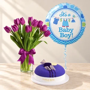 Purple tulips in a clear vase with a violet Blue Velvet cake and one blue Baby Boy balloon