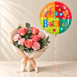 Coral-pink roses and pink carnations with one colourful Happy Birthday foil balloon