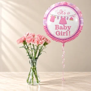 Soft-pink carnations in a slender glass vase with one pink Baby Girl balloon