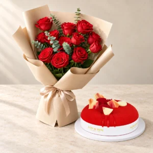 Passionate Scarlet red roses and eucalyptus beside a small round Red Velvet cake